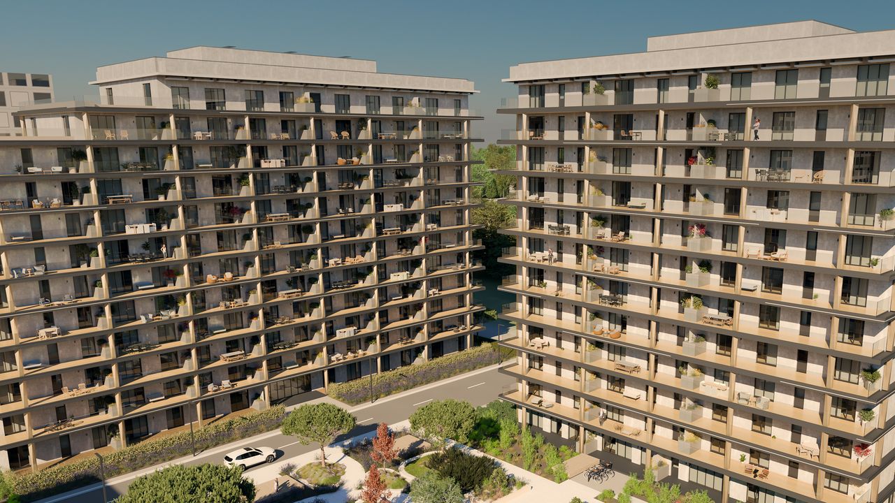 Aerial overview of buildings B3 (left) and B2 (right), with the internal road and the upper part of the garden in front; a few people on the paths and balconies.
